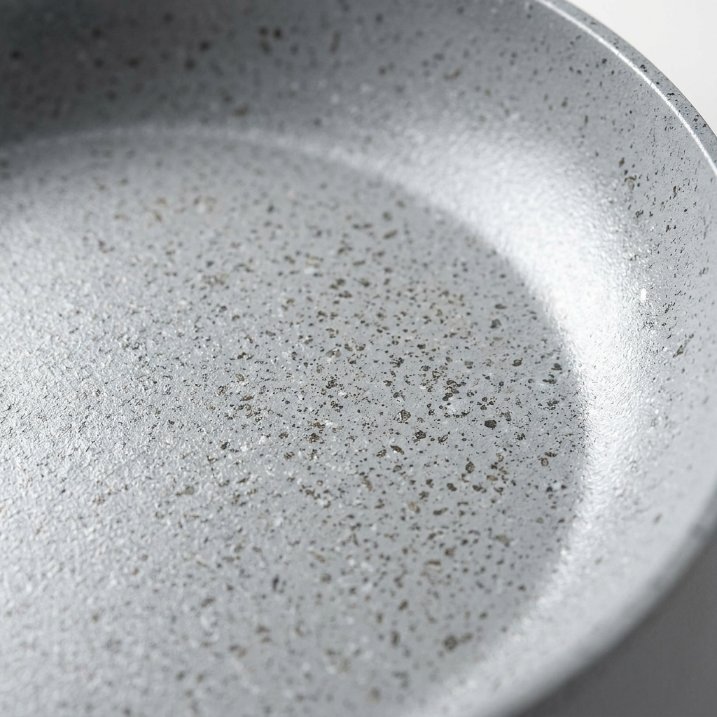 Close-up of a Granitestone pan's speckled gray nonstick surface and mineral coating texture